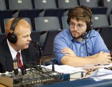 Cavalier chats with C-N men's hoops coach Chuck Benson after the Eagles win over Tusculum