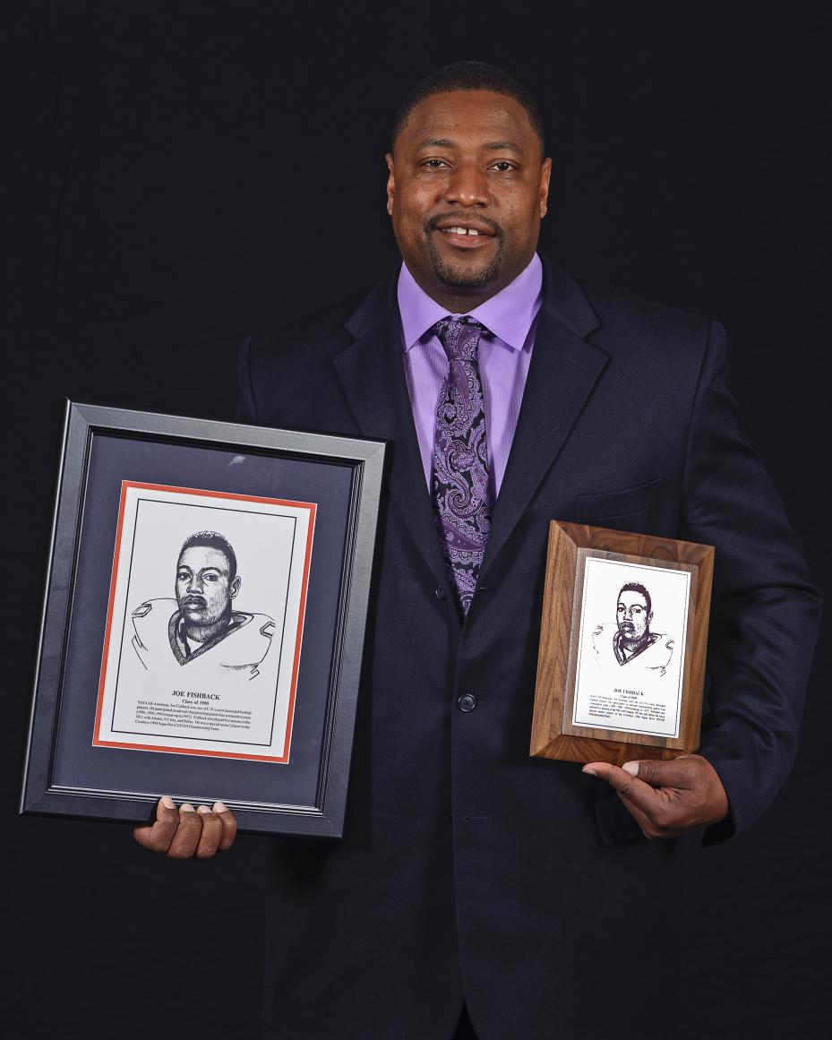 Joe Fishback holds his plaques as  he is inducted into the Carson-Newman Hall of Fame in 2013.