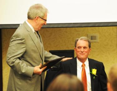 Carson-Newman president Randall O'Brien presents Barger with his Hall of Fame plaque