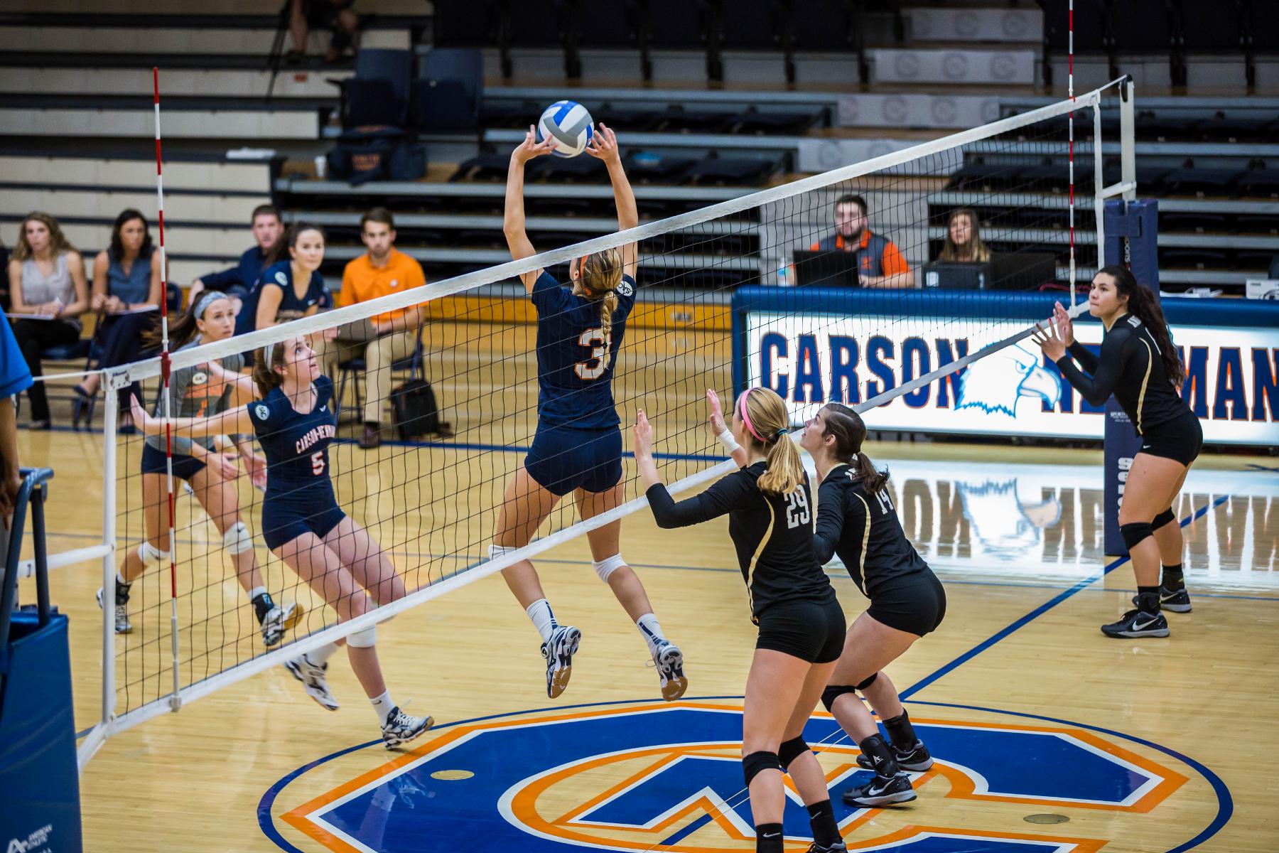 Late mistakes cost Eagles in four-set loss to Trojans